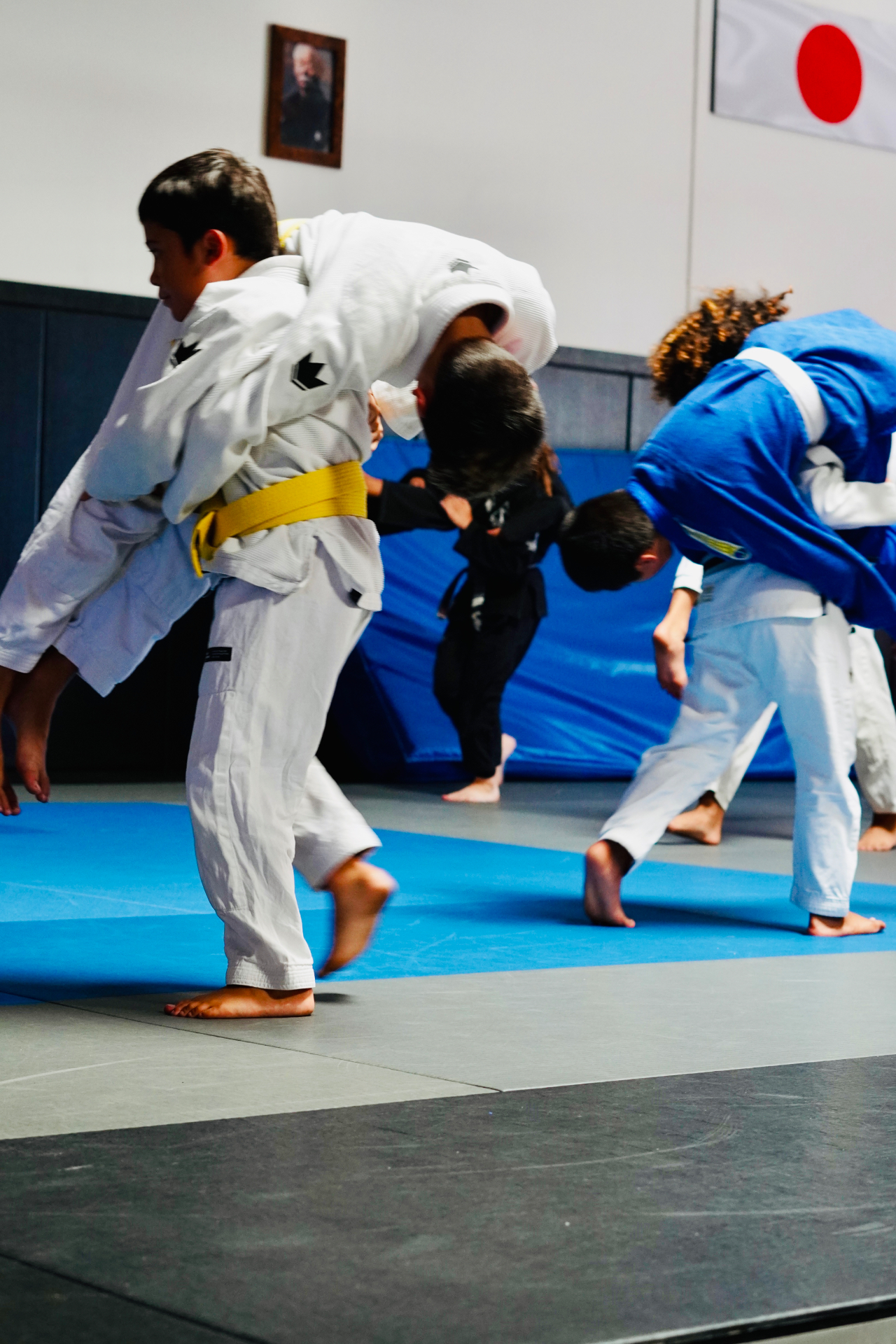 GDA youth students drilling takedowns together in the training room