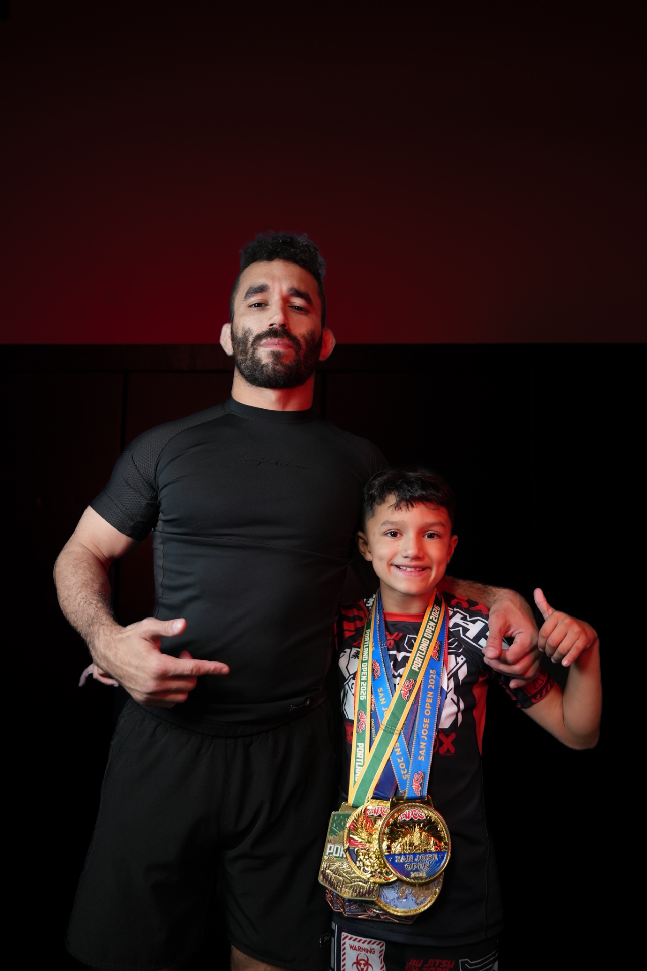 GDA coach with a young athlete holding competition medals